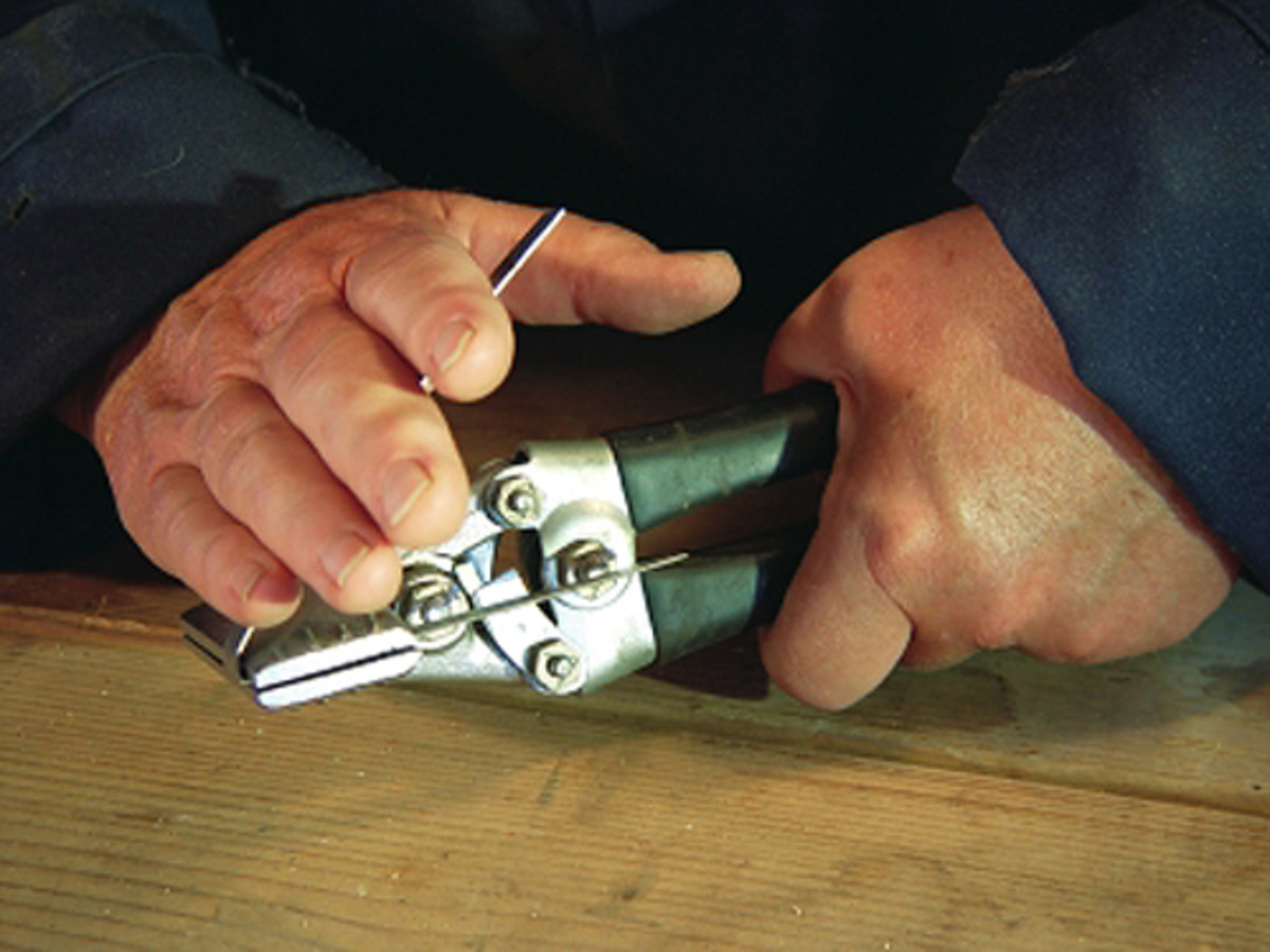  The metal is placed in the pliers and bent by hand as close to the pliers' jaws as possible.